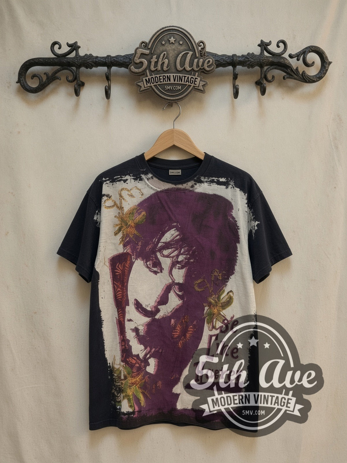 The Cure all-over-print vintage band t-shirt, front view on a display rack