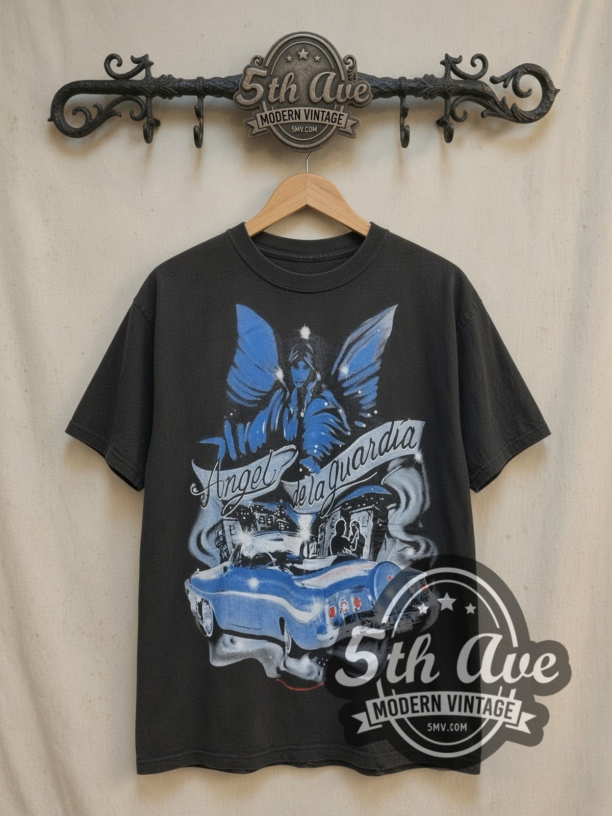 Rollin Hard Angel de la Guardia Lowrider vintage graphic tee, front view on a display rack