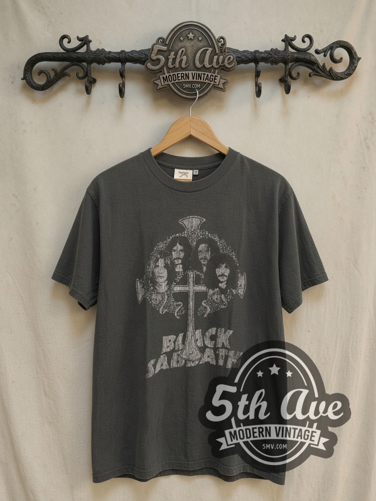 Black Sabbath Band Photo Cross Logo vintage band t-shirt, front view on a display rack