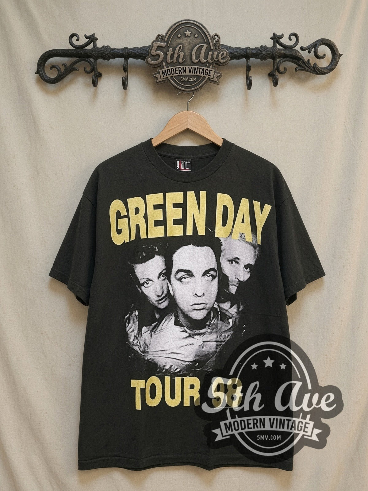 Green Day Nimrod Tour T-Shirt Classic Band Design vintage band t-shirt, front view on a display rack