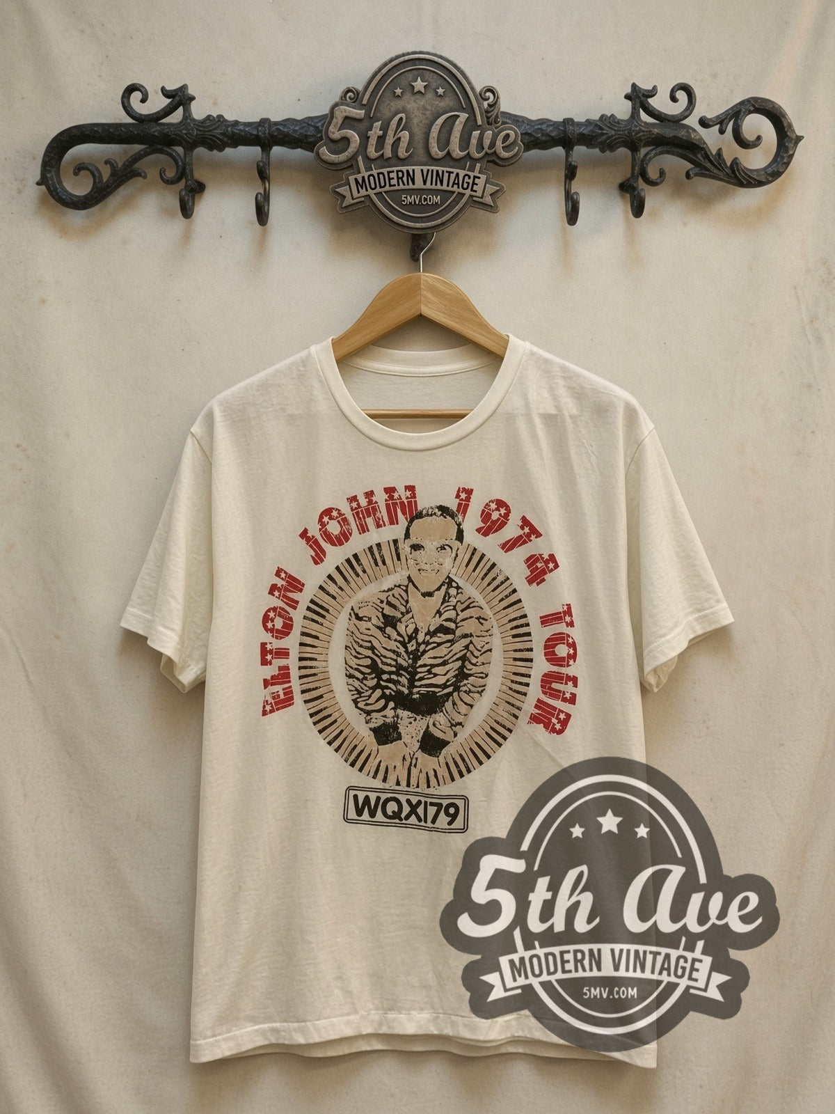 Elton John 1974 Tour Concert vintage band t-shirt, front view on a display rack