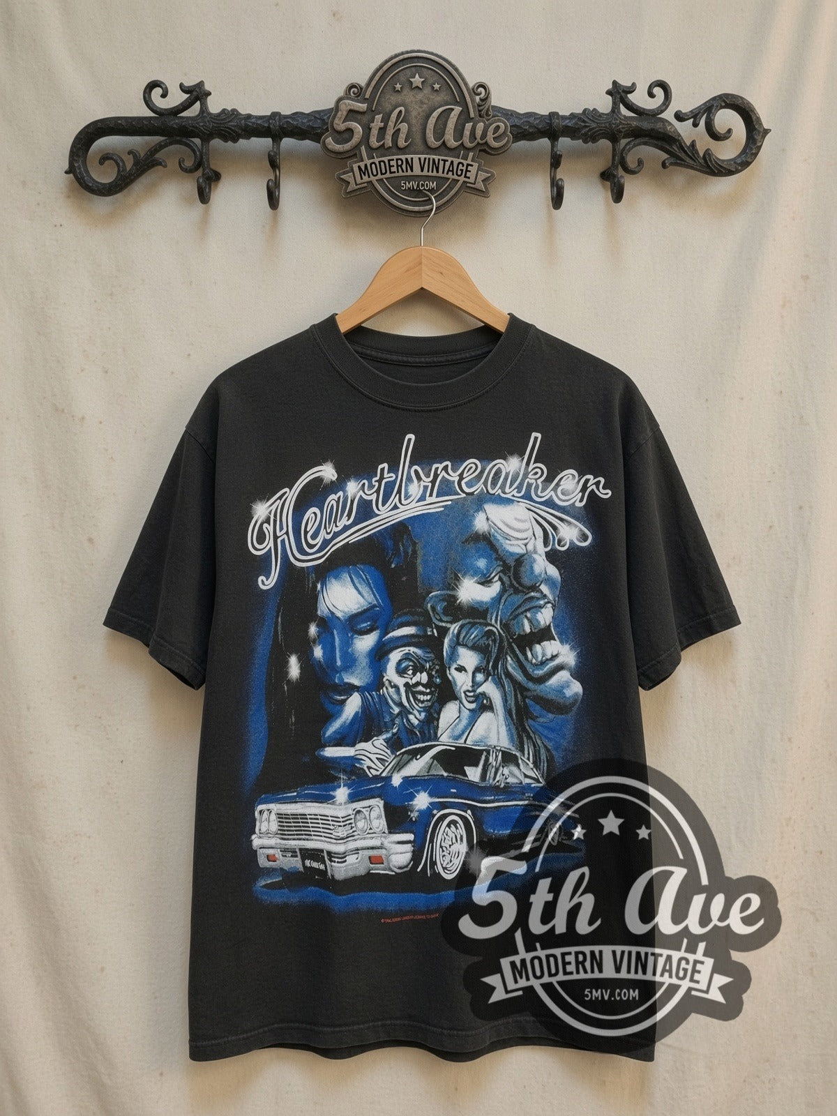 Rollin Hard Heartbreaker Lowrider vintage graphic tee, front view on a display rack