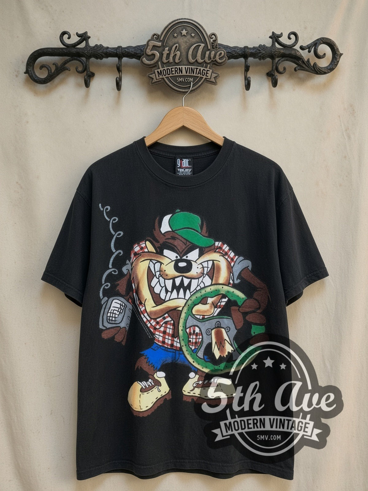 Looney Tunes Taz's Truckin' Co. vintage cartoon tee, front view on a display rack