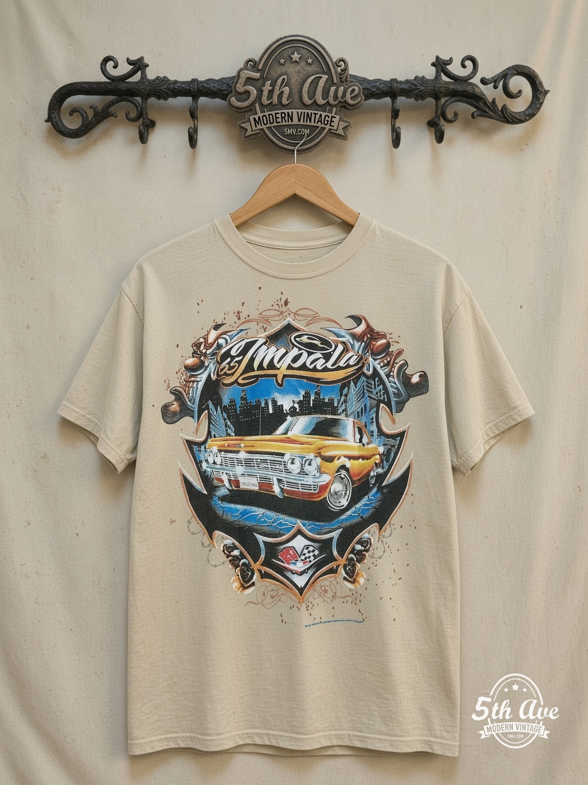 Vato Vibes: Rolling Hard with the Golden Impala Tee – Vintage Band T-Shirt — front on locked cream ornate 5th Ave rack