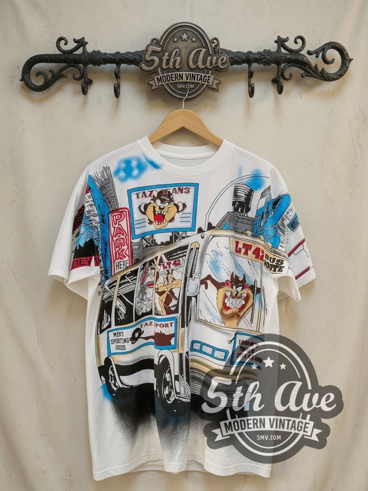 Looney Tunes On the Move all-over-print vintage cartoon tee, front view on a display rack
