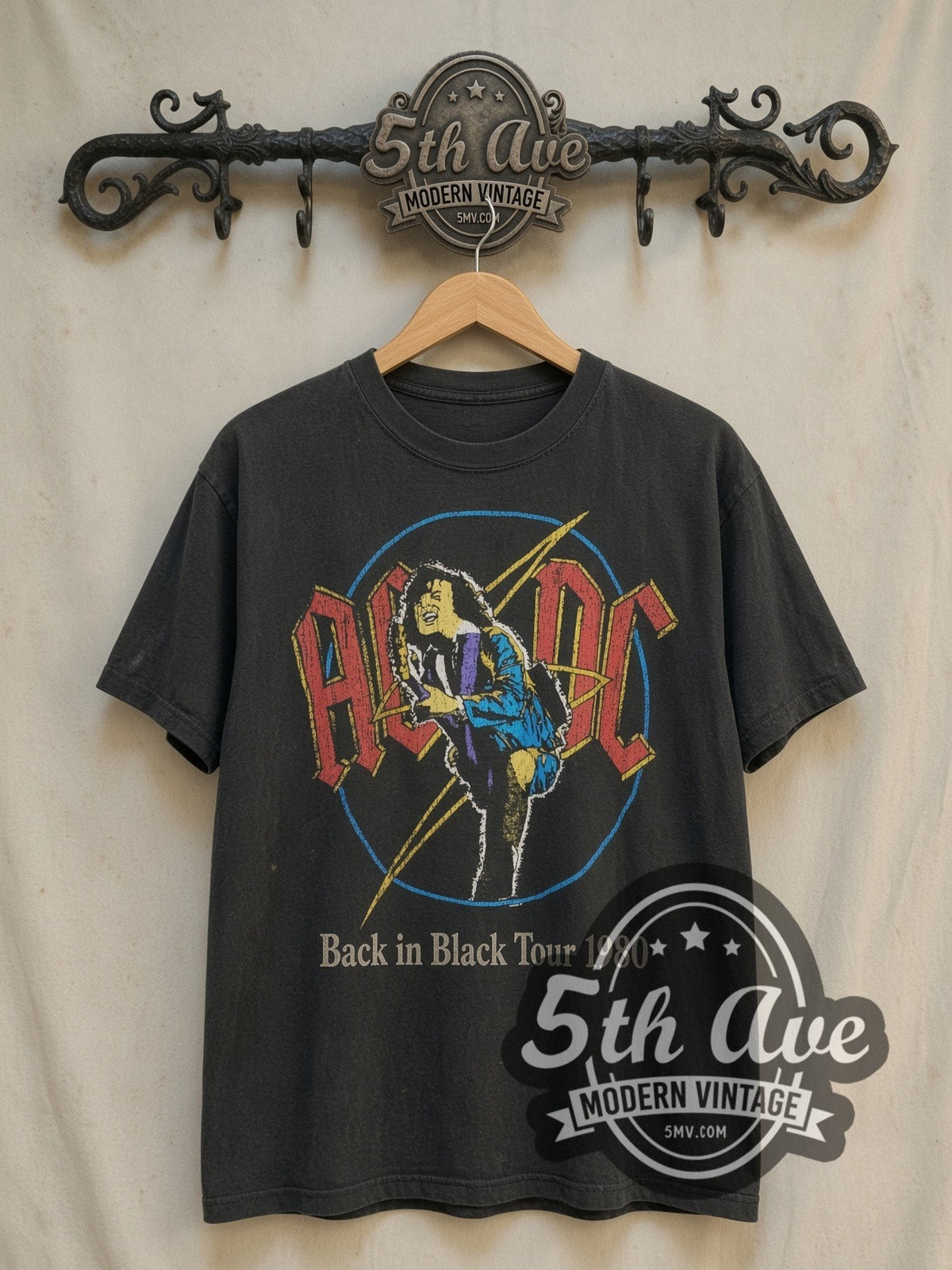 AC/DC Back in Black Tour 1980 vintage band t-shirt in black, front view on a display rack