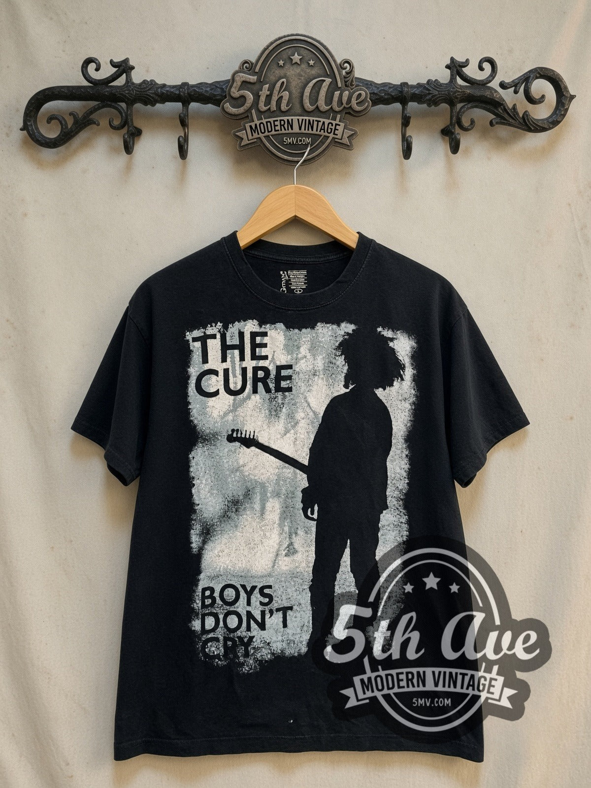 The Cure Boys Don't Cry vintage band t-shirt, front view on a display rack