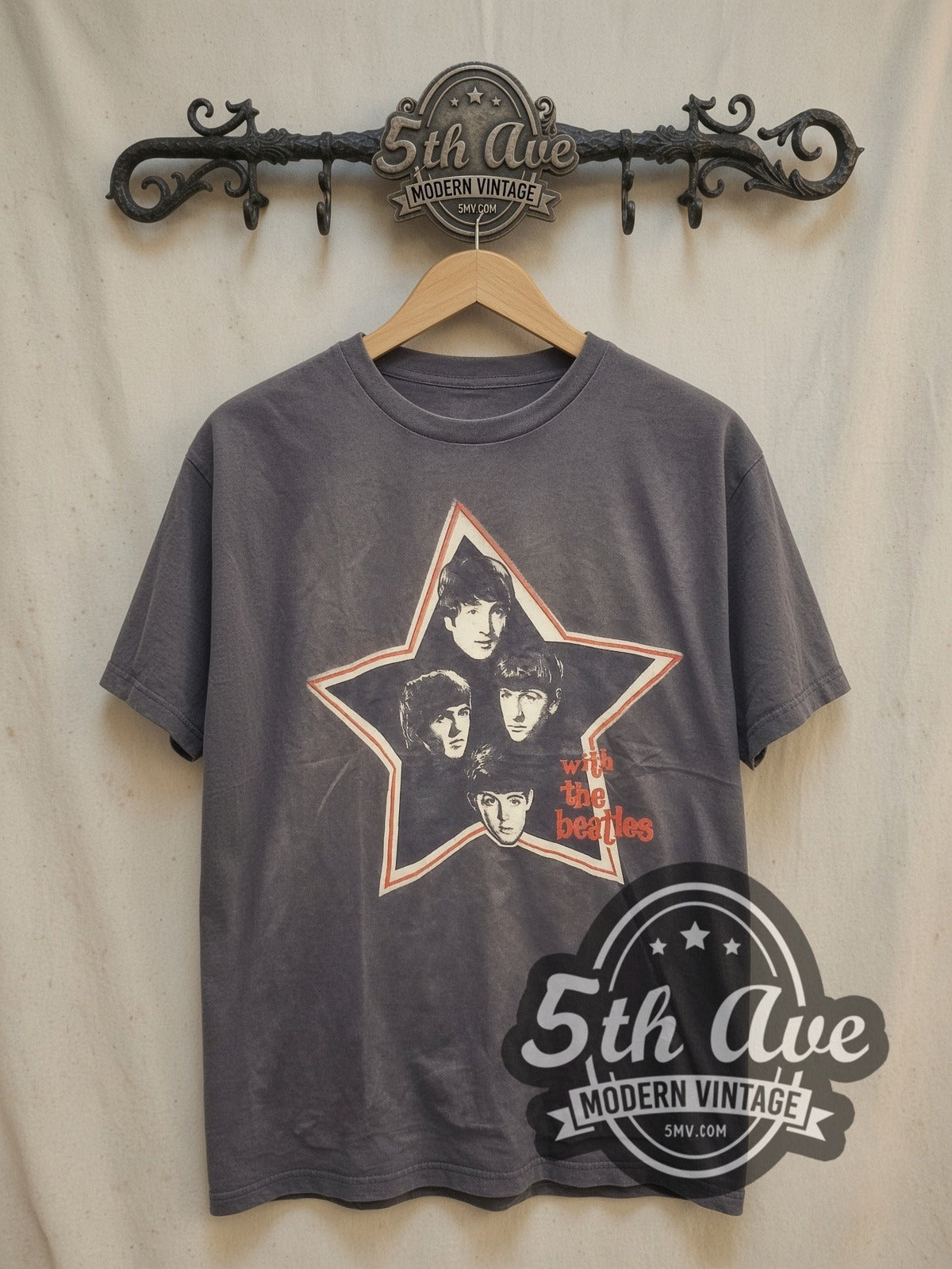 The Beatles With The Beatles Star Portraits vintage band t-shirt, front view on a display rack