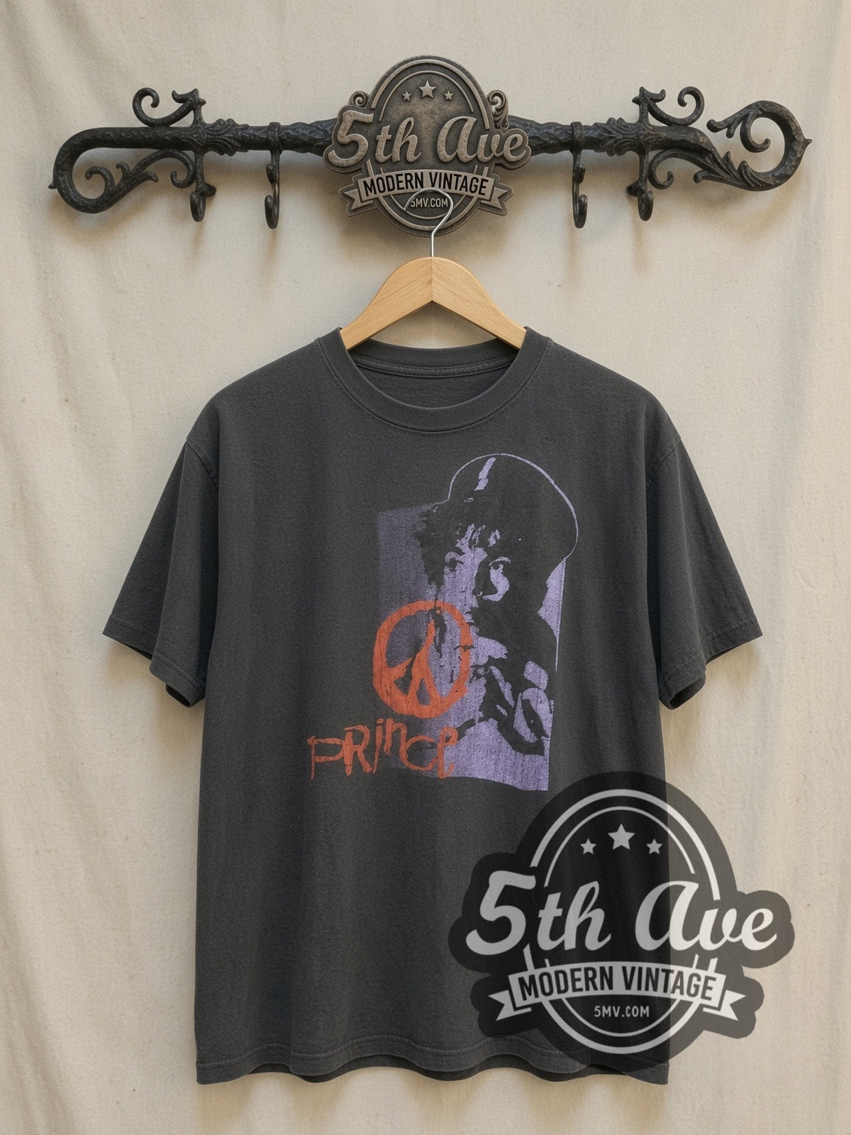 Prince Purple Portrait Orange Peace Sign vintage band t-shirt, front view on a display rack