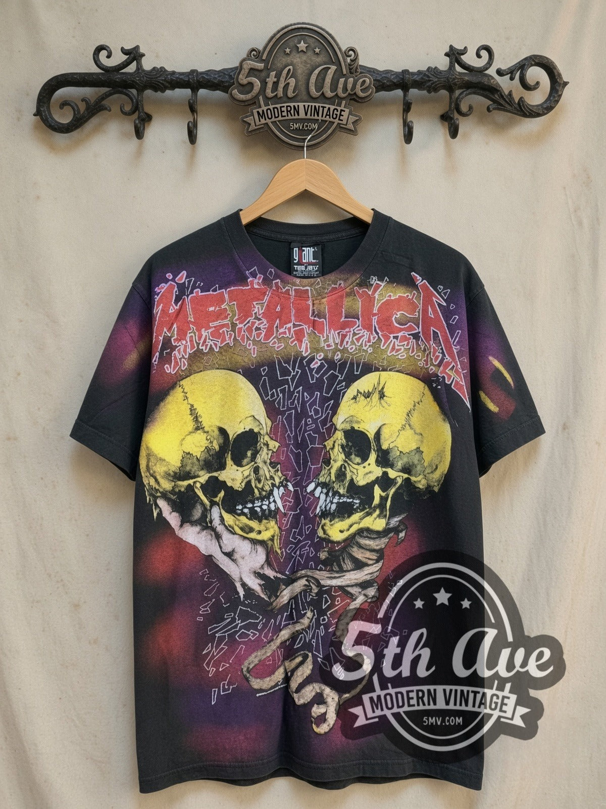 Metallica Twin Skulls all-over-print vintage band t-shirt, front view on a display rack