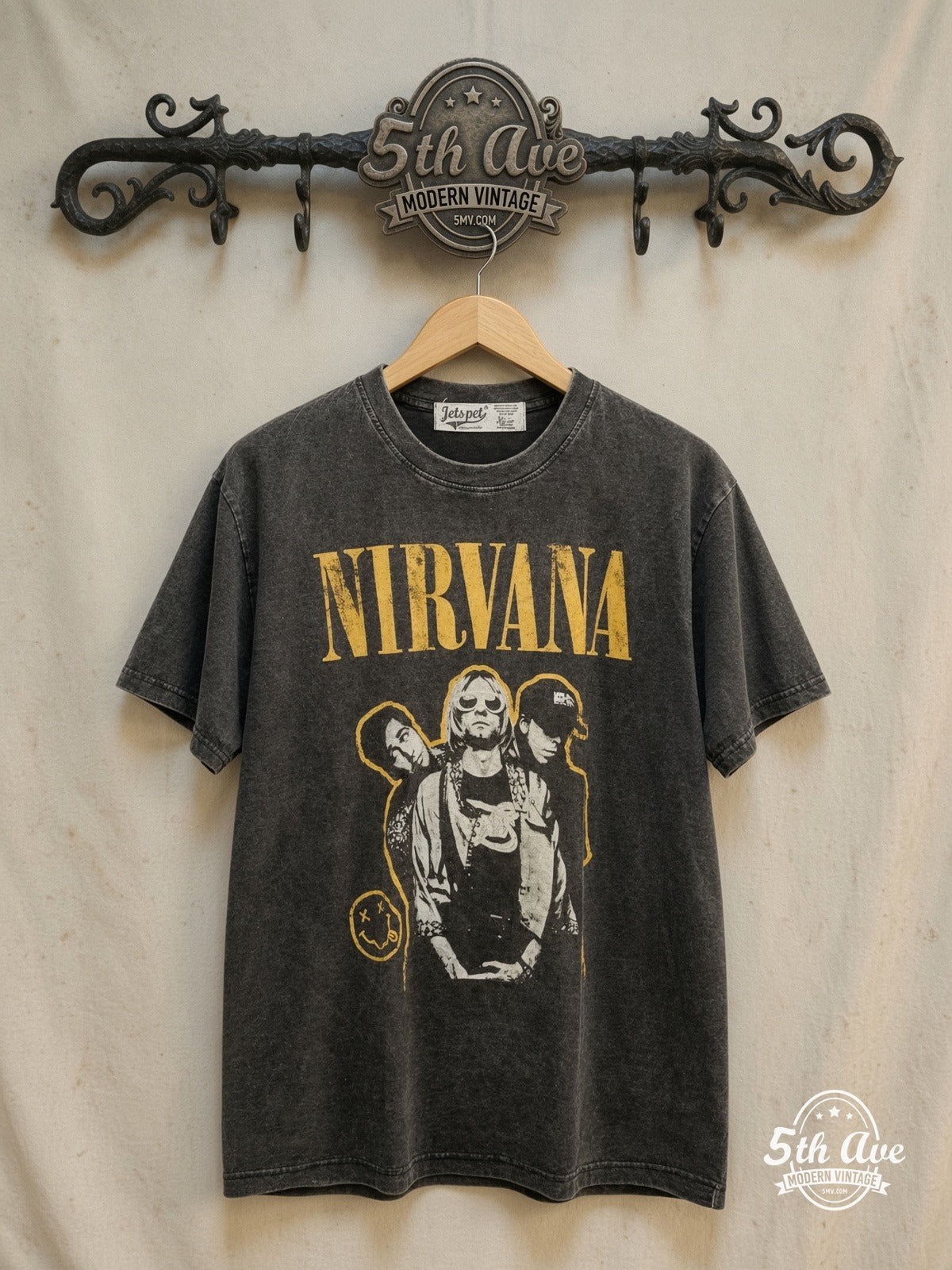 Nirvana – Yellow Logo Smiley Band Photo – Vintage Band T-Shirt — front on locked cream ornate 5th Ave rack