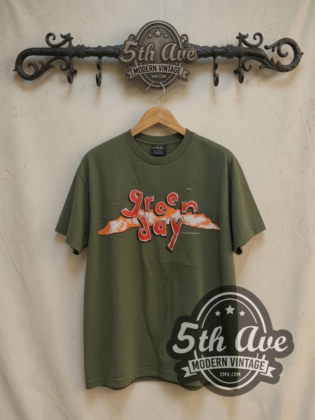 Green Day Dookie Logo Flies vintage band t-shirt, front view on a display rack