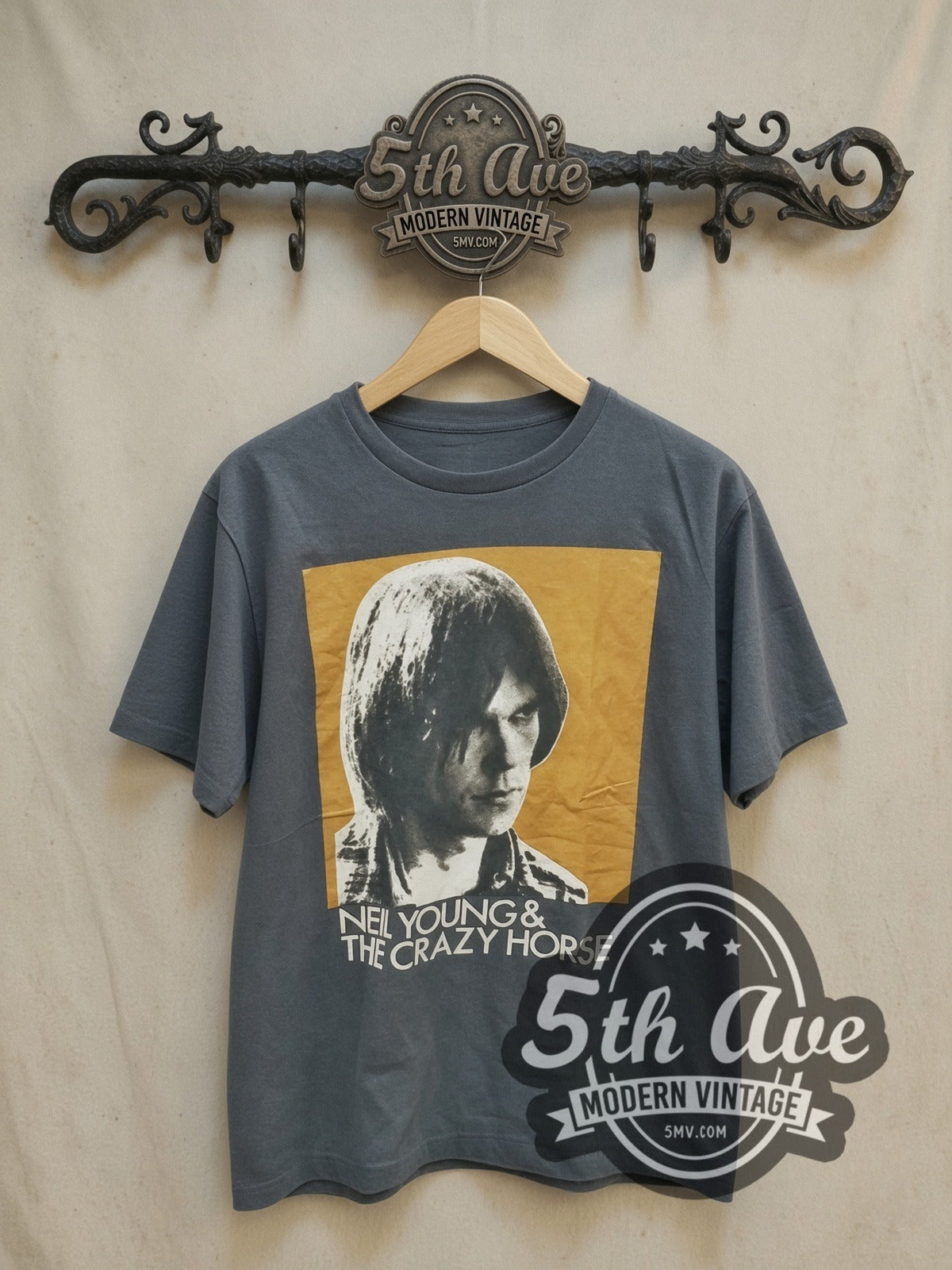 Neil Young and Crazy Horse Color Portrait vintage band t-shirt, front view on a display rack