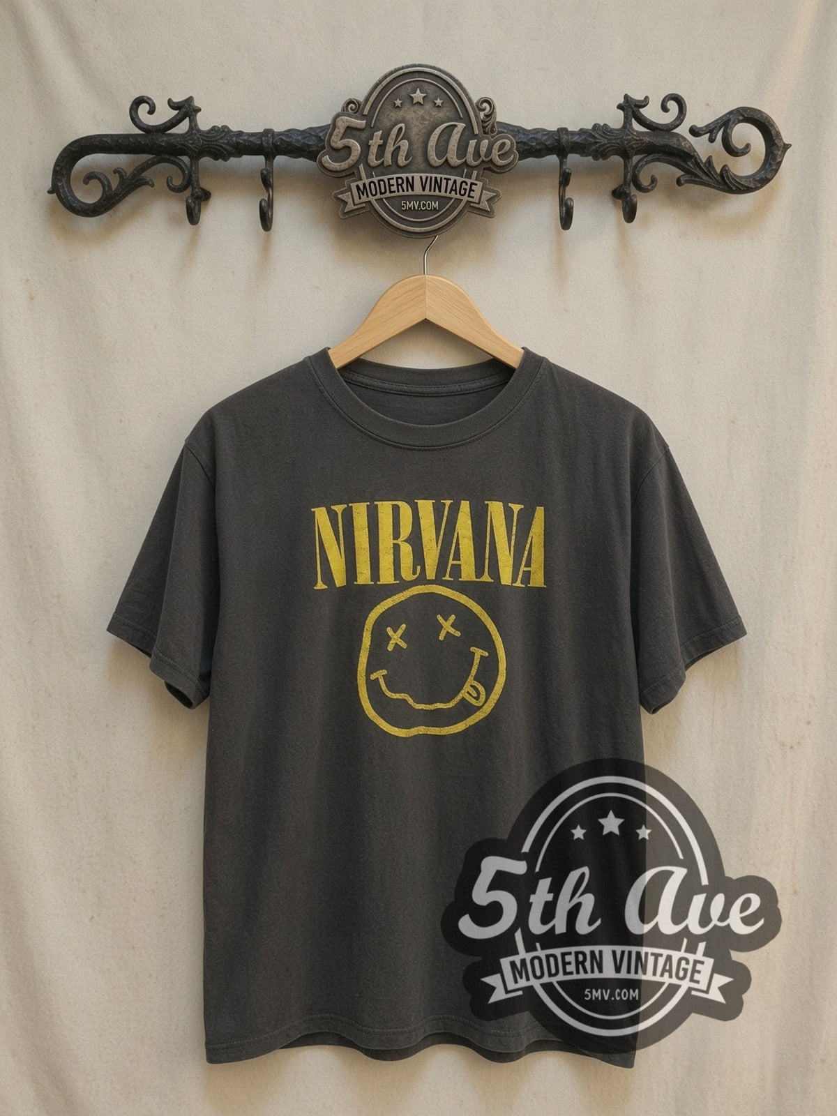 Nirvana with Kurt Cobain's Sub Pop Records Sketch vintage band t-shirt, front view on a display rack