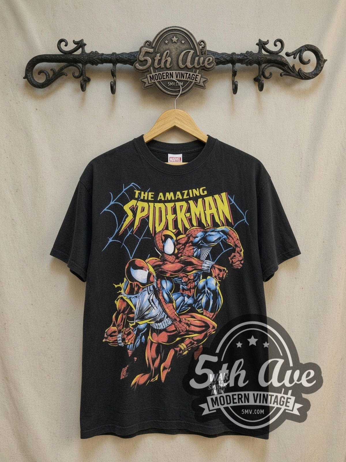 Spider-Man all-over-print graphic tee, front view on a display rack