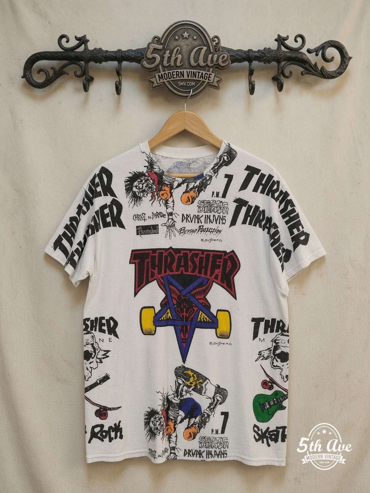 Thrasher x Pushead Skate Collage all-over-print graphic tee in white, front view on a display rack