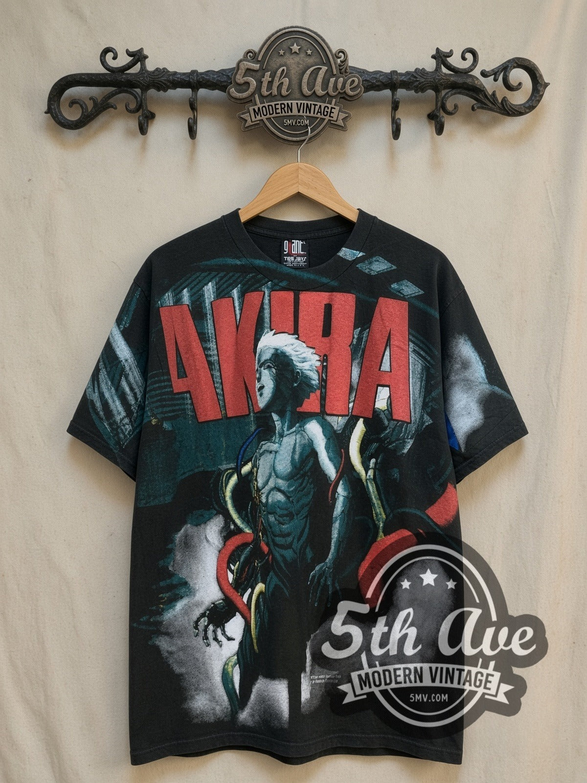 AKIRA Tetsuo Shima all-over-print vintage graphic t-shirt, front view on a display rack