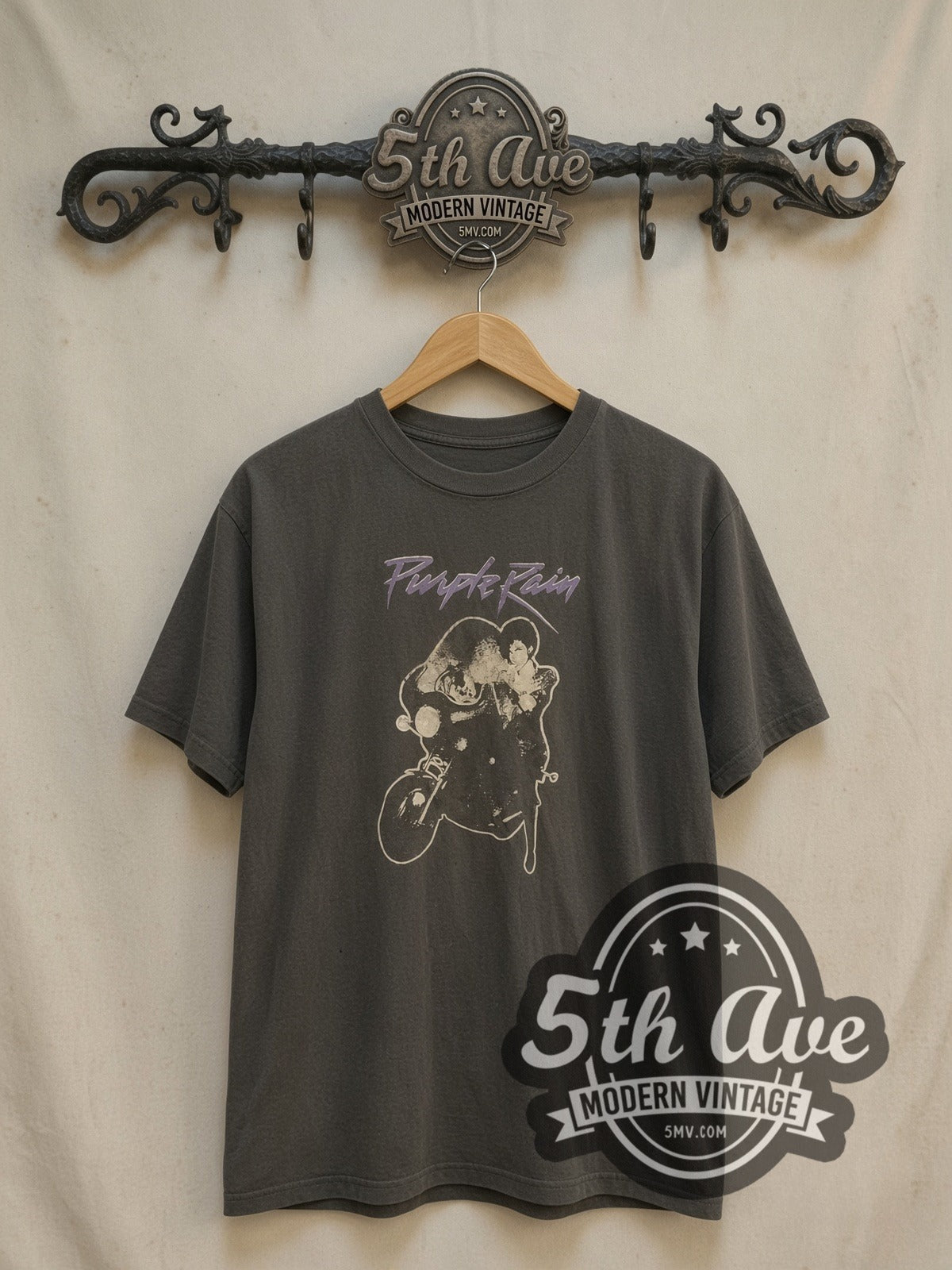 Prince Purple Rain Script Motorcycle vintage band t-shirt, front view on a display rack