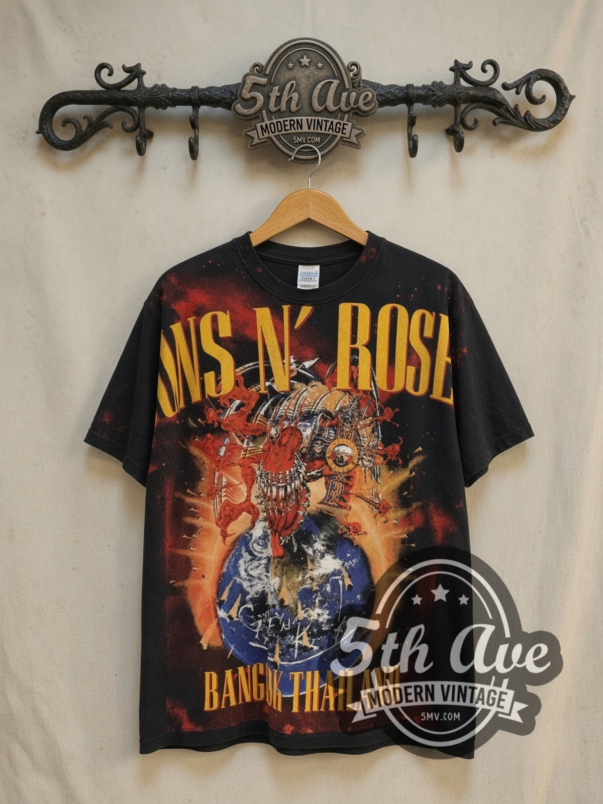Guns N' Roses Bangkok World Tour 2025 all-over-print vintage band t-shirt, front view on a display rack