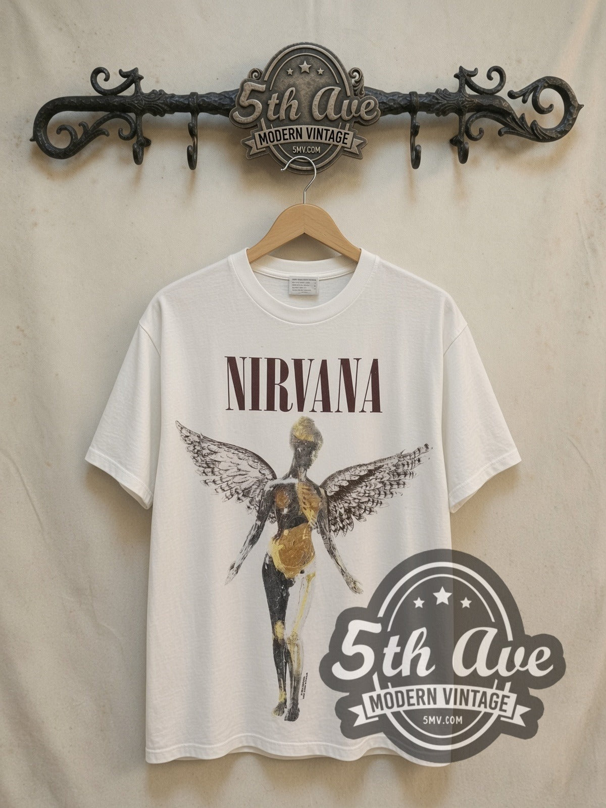 Nirvana In Utero Classic Angel Dark Logo vintage band t-shirt in white, front view on a display rack