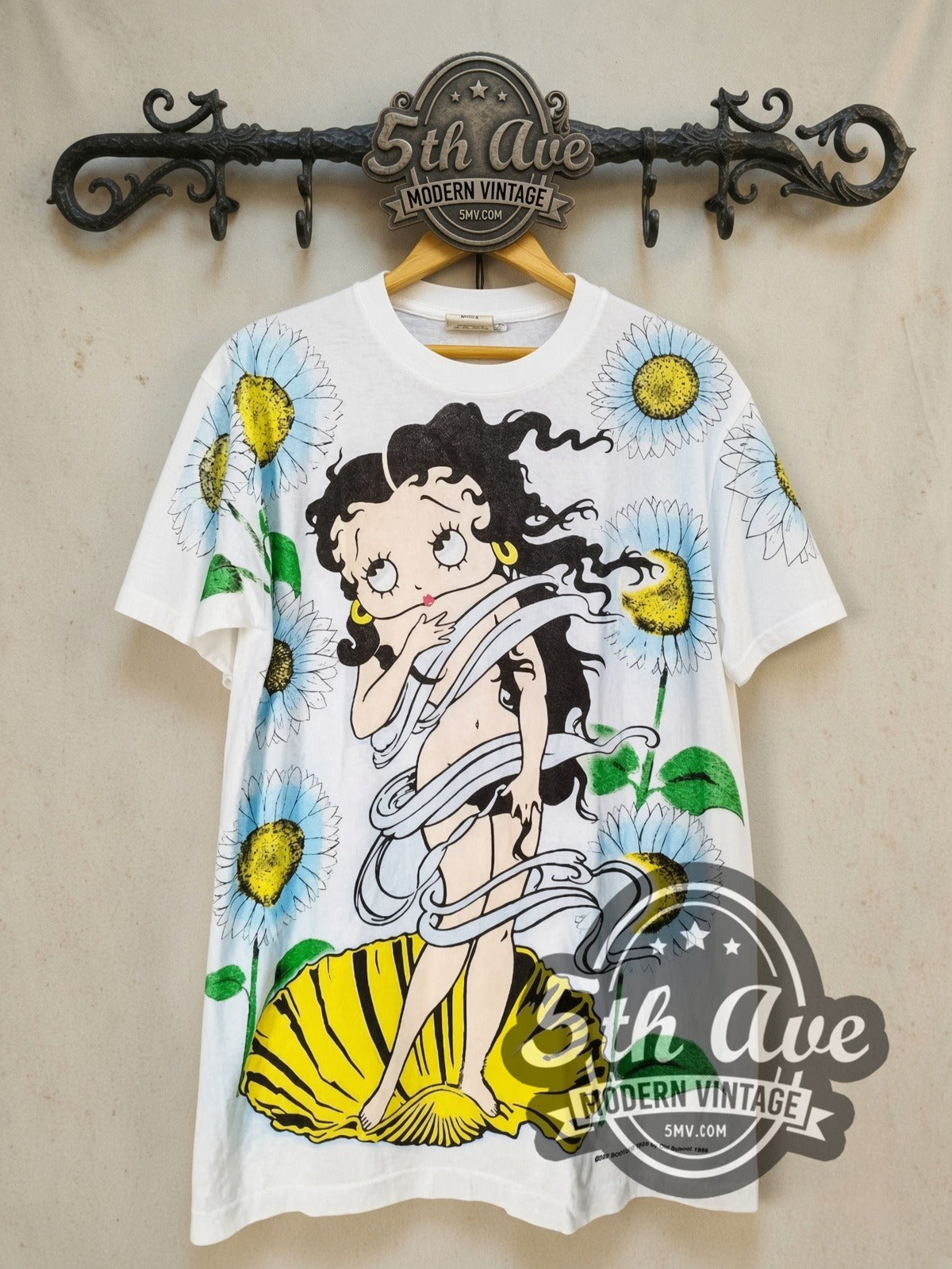 Betty Boop Birth of Venus all-over-print vintage cartoon tee, front view on a display rack