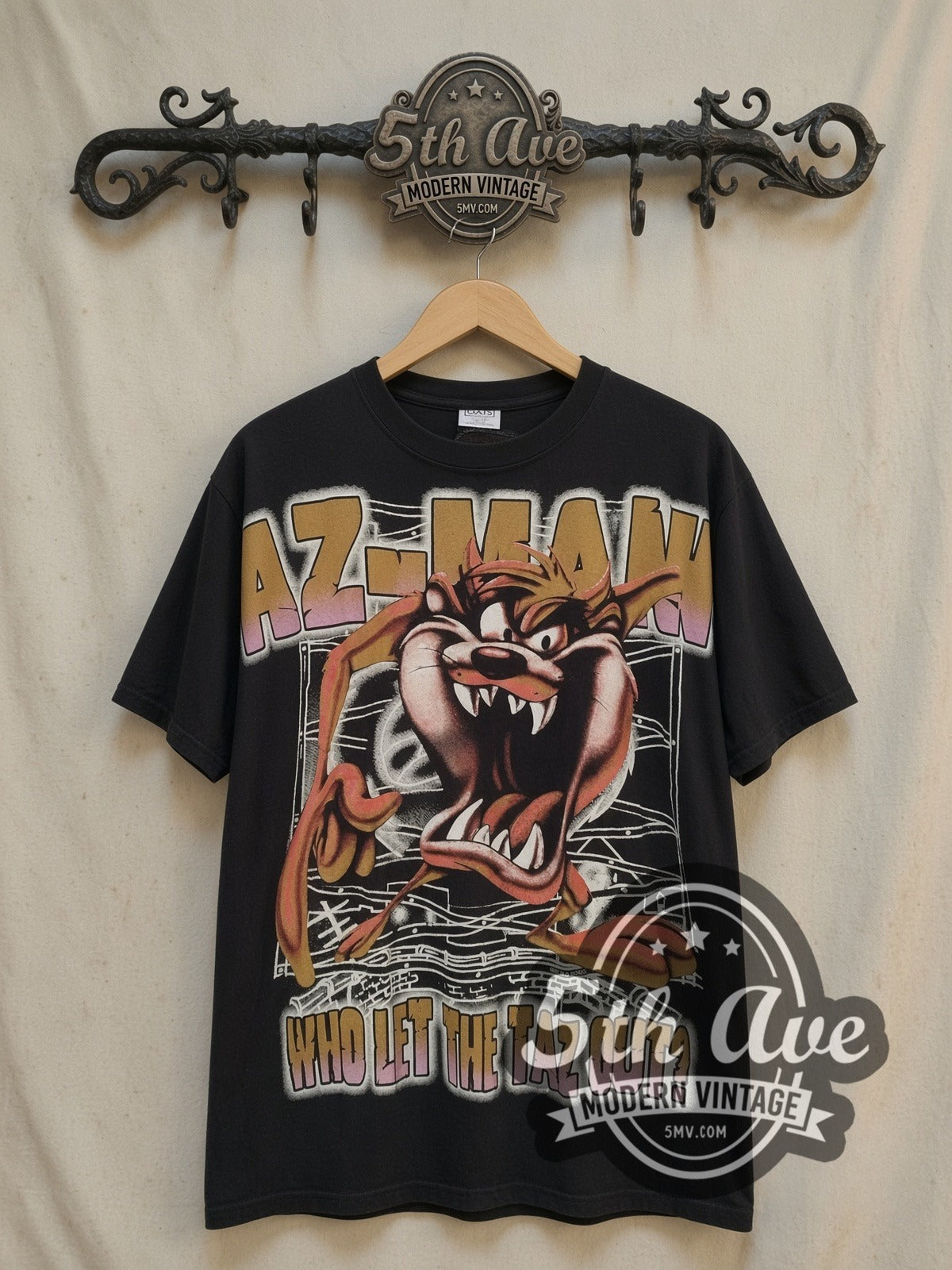 Looney Tunes Taz-Mania Who Let the Taz Out all-over-print vintage cartoon tee, front view on a display rack