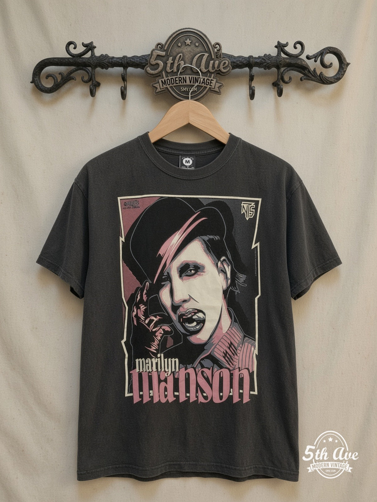 Marilyn Manson – 100% Cotton New Vintage Band T-Shirt – Vintage Band T-Shirt — front on locked cream ornate 5th Ave rack