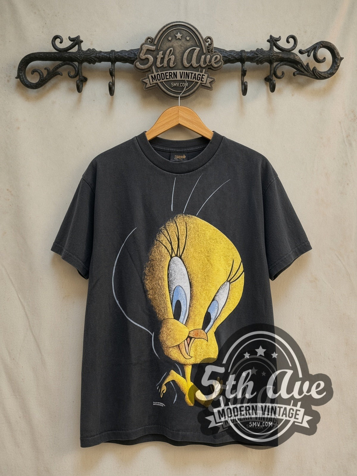 Looney Tunes Tweety vintage cartoon tee in black, front view on a display rack