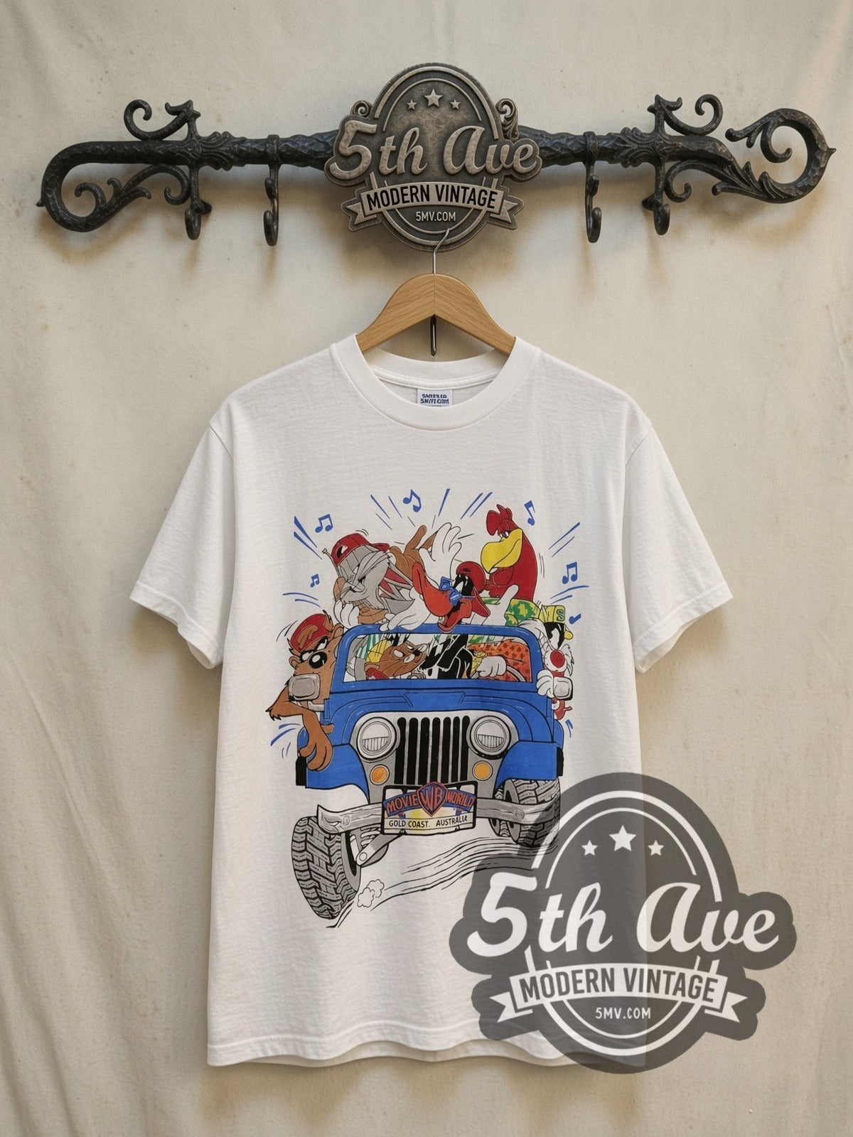 Looney Tunes Warner Brothers Gold Coast graphic tee, front view on a display rack