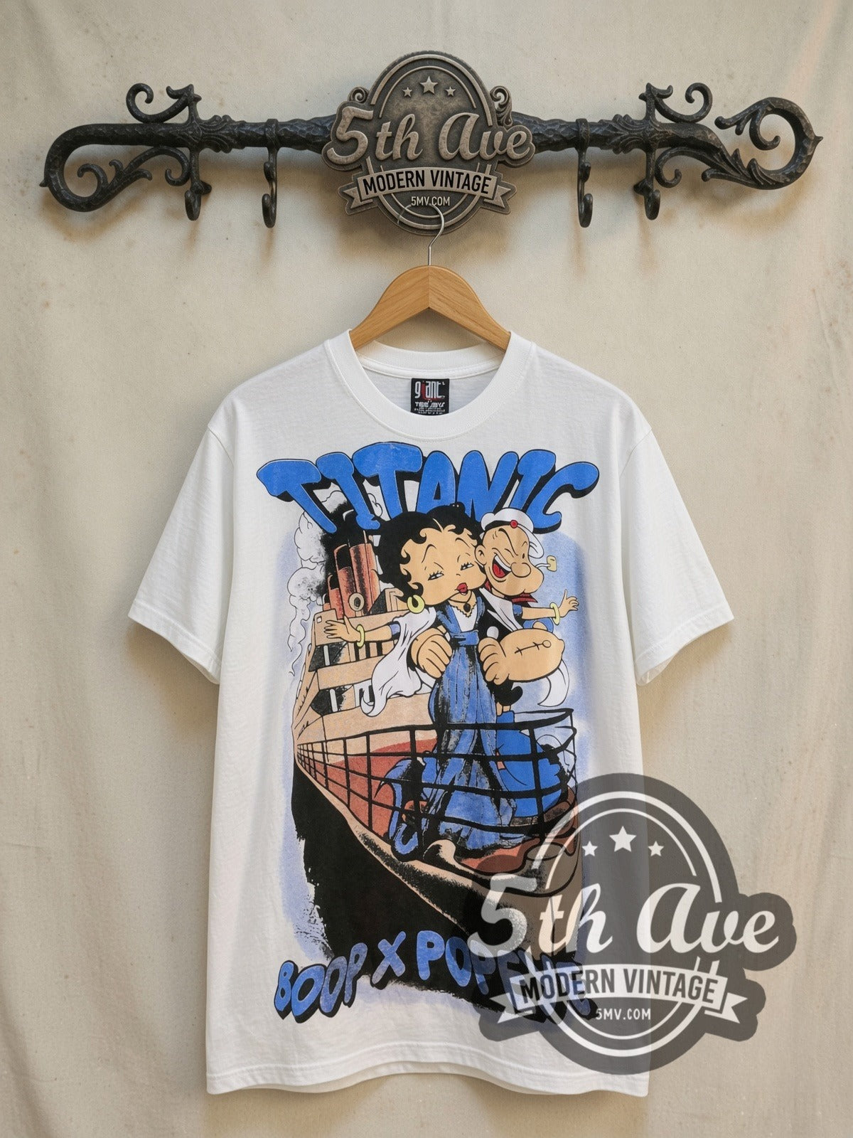 Betty Boop, Popeye and Titanic all-over-print vintage cartoon tee, front view on a display rack
