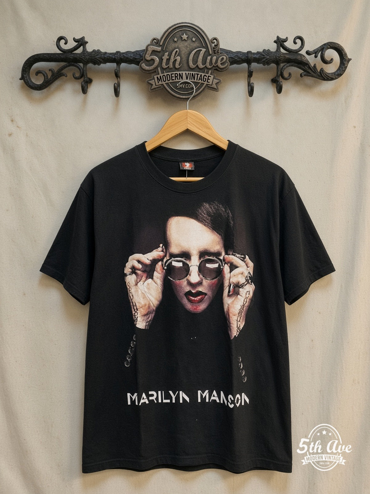 Marilyn Manson – Retro Vintage Iconic Band Design T-Shirt – Vintage Band T-Shirt — front on locked cream ornate 5th Ave rack