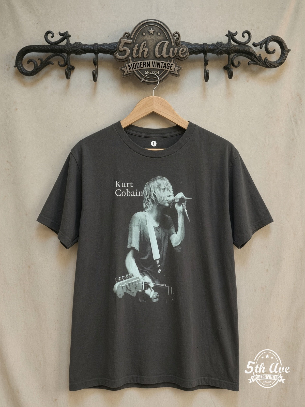 Nirvana – Vintage-Inspired Streetwear T-Shirt: Single Stitch, Light Blue Screen – Vintage Band T-Shirt — front on locked cream ornate 5th Ave rack