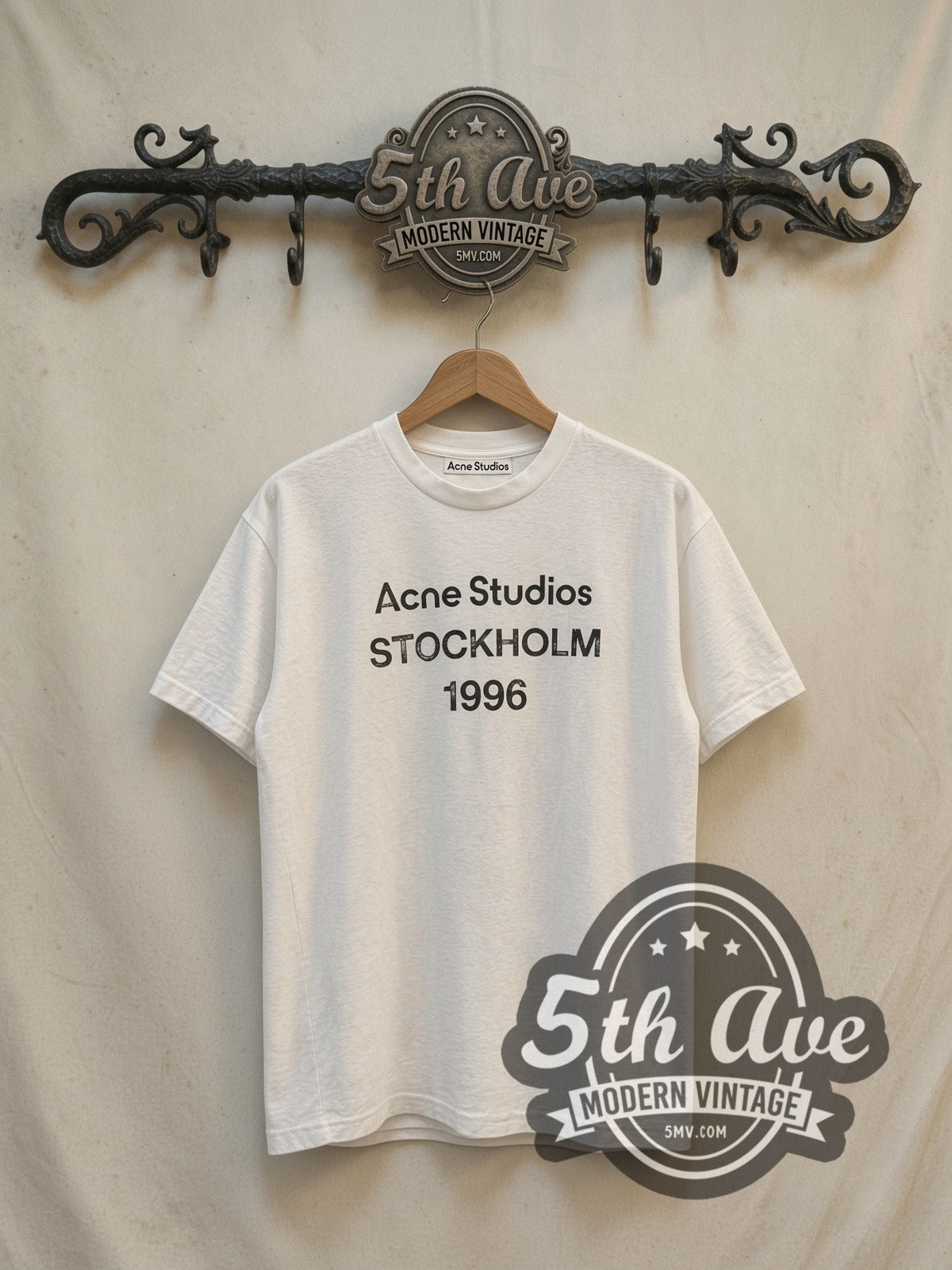 Acne Studios Stockholm 1996 vintage graphic tee, front view on a display rack