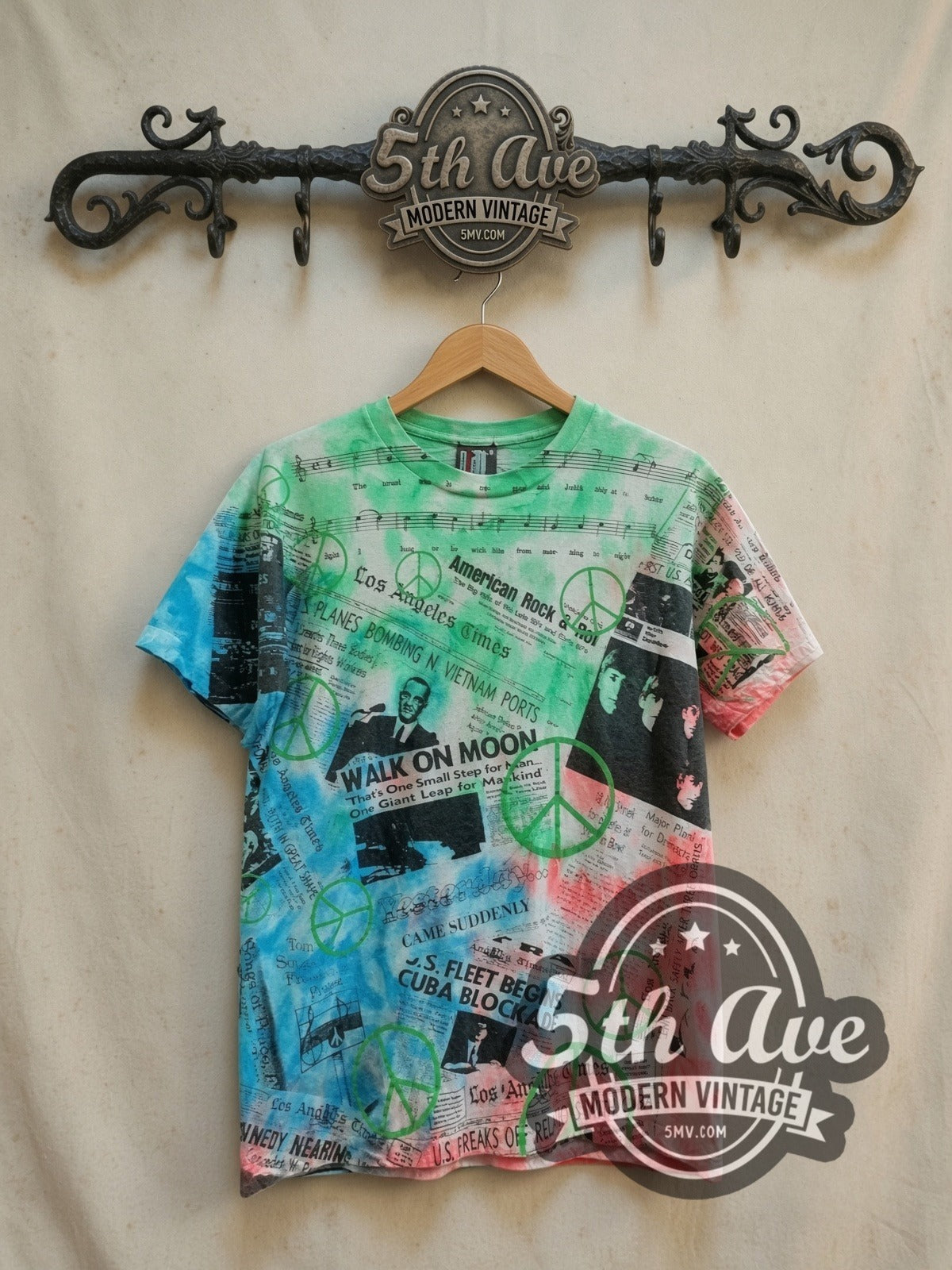 60s Pop Culture Tie Dye Collage vintage graphic tee, front view on a display rack