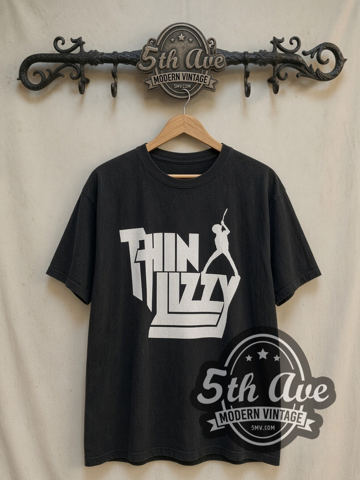 Thin Lizzy Stacked White Logo Guitarist Silhouette vintage band t-shirt, front view on a display rack