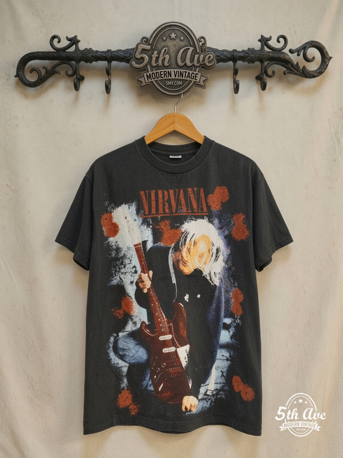 Nirvana Kurt Cobain Red Guitar vintage band t-shirt, front view on a display rack