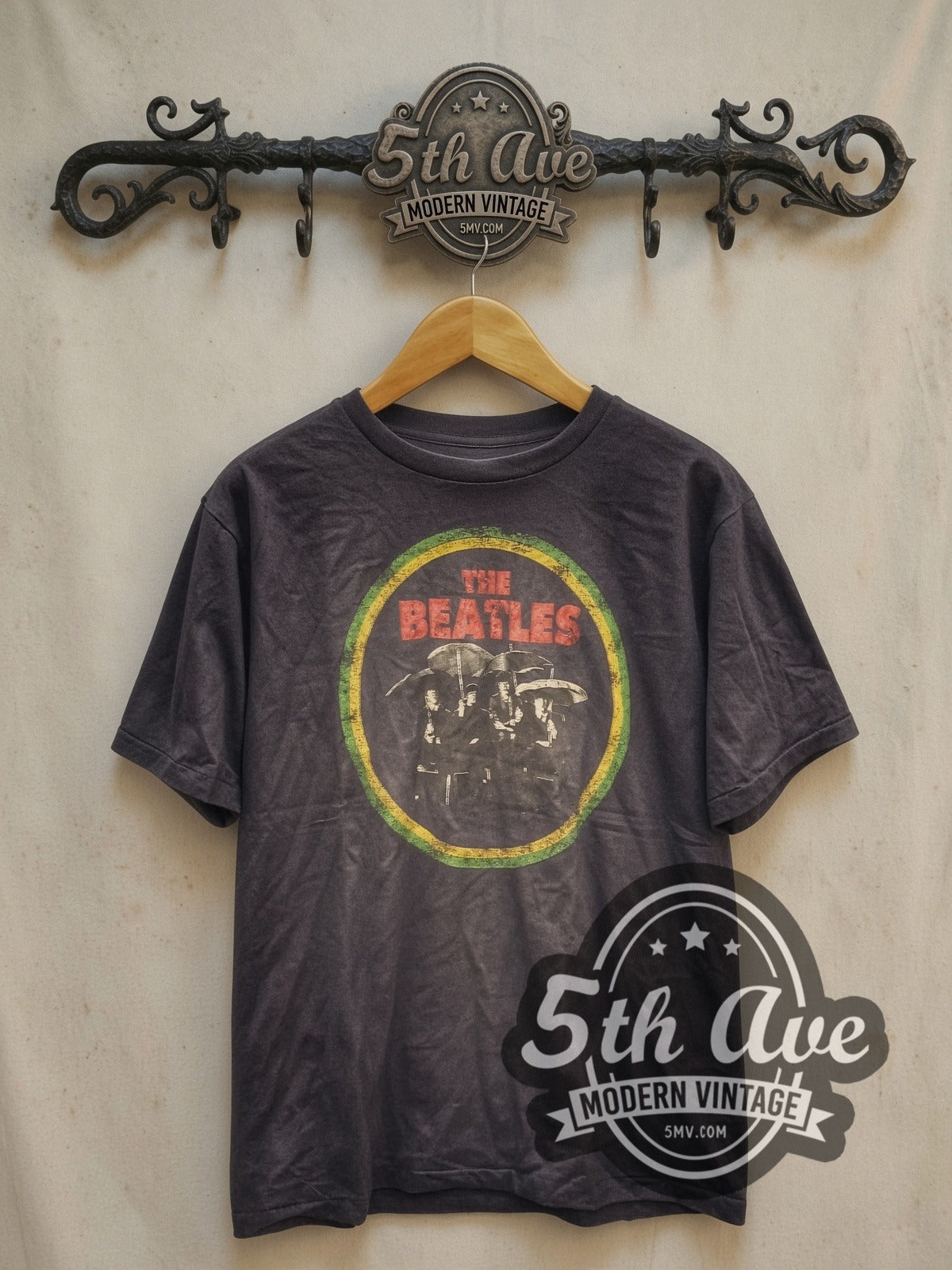 The Beatles Circle Logo Band Photo vintage band t-shirt, front view on a display rack