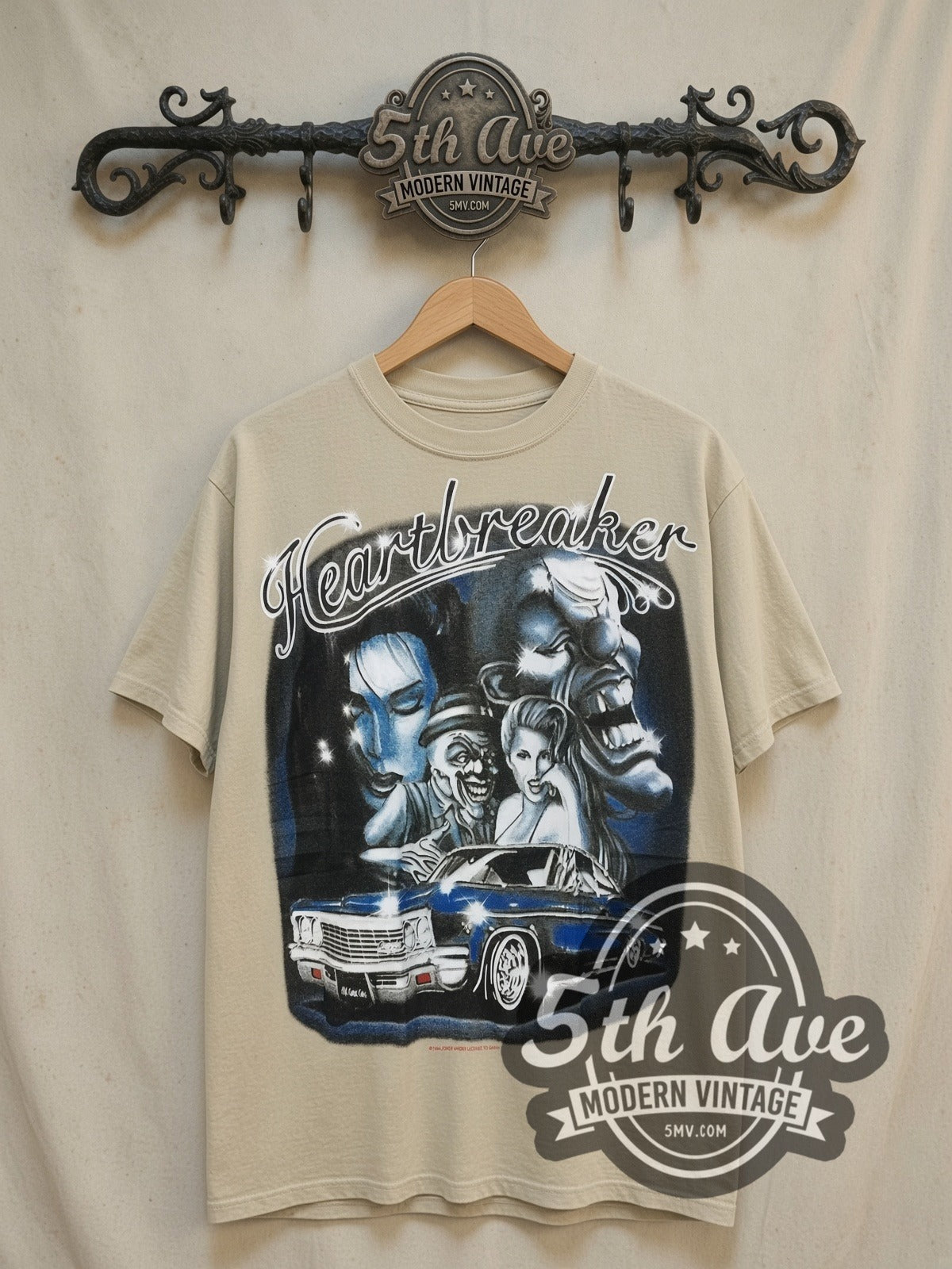 Rollin Hard Heartbreaker Lowrider vintage graphic tee in sand, front view on a display rack