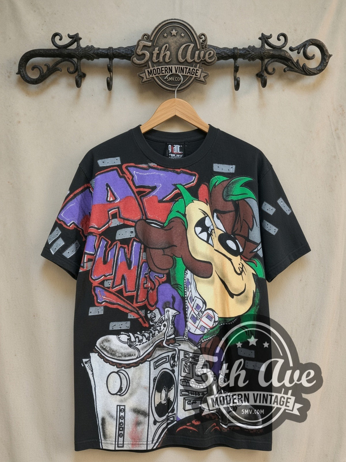 Looney Tunes Taz-Mania Wild Style all-over-print vintage cartoon tee, front view on a display rack