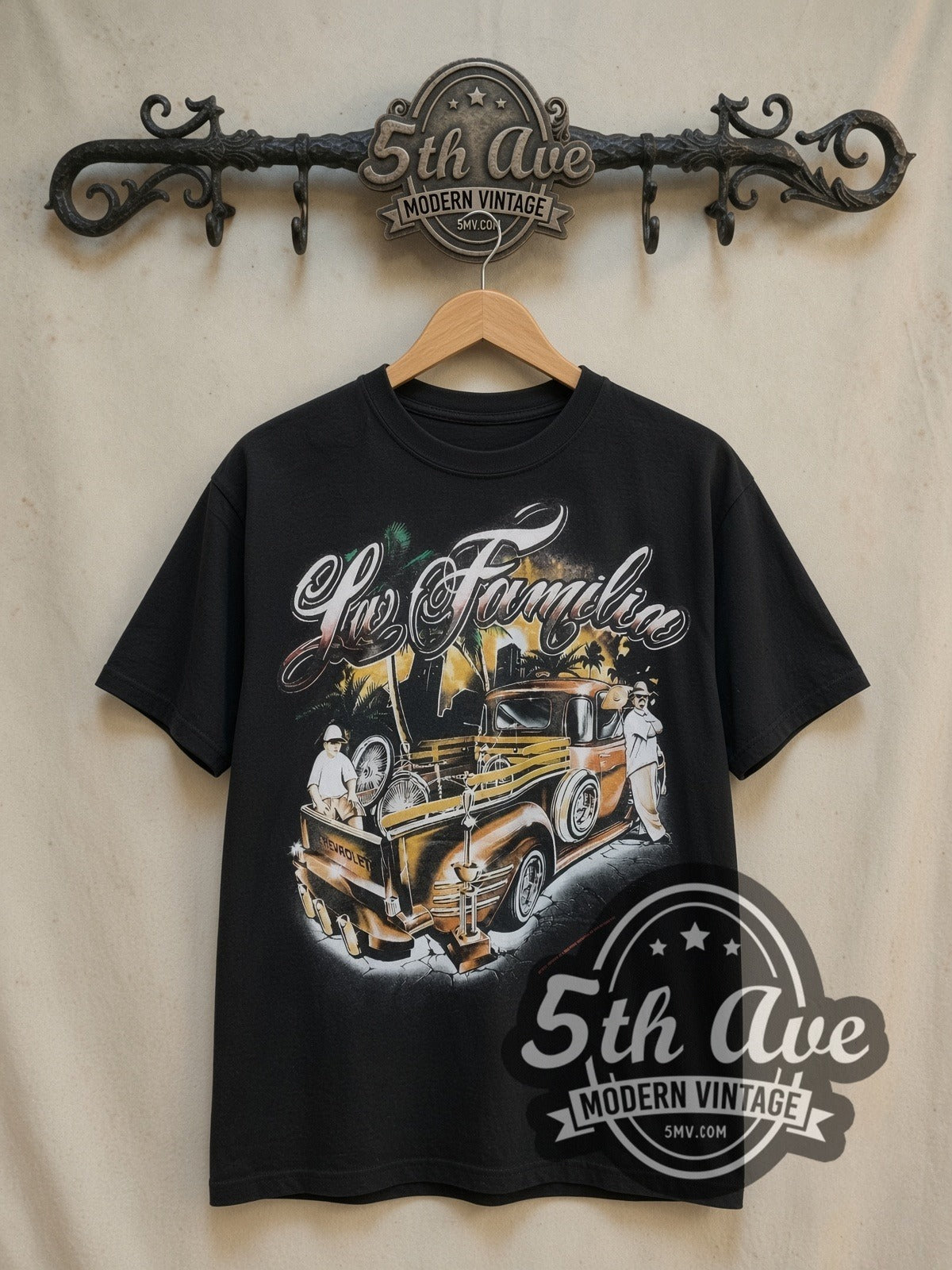 Rollin Hard For Familia Lowrider vintage graphic tee, front view on a display rack