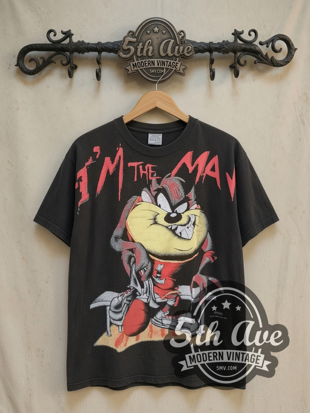 Taz-Mania Slam Dunk all-over-print vintage cartoon tee, front view on a display rack