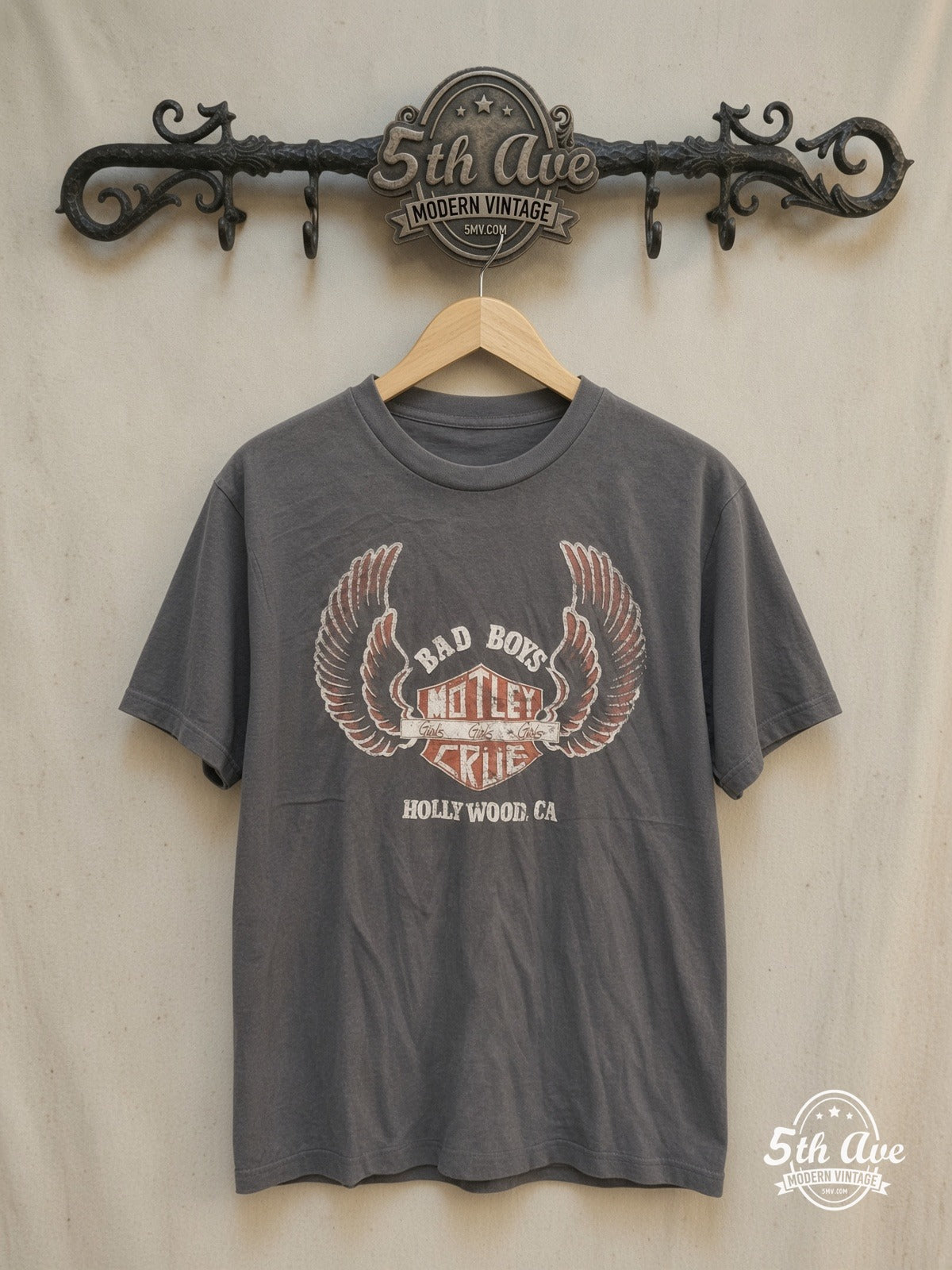Mötley Crüe – Bad Boys Girls Girls Girls Winged Shield – Vintage Band T-Shirt — front on locked cream ornate 5th Ave rack