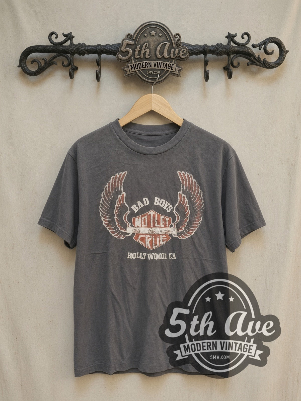 Mötley Crüe Bad Boys Girls Girls Girls Winged Shield vintage band t-shirt, front view on a display rack