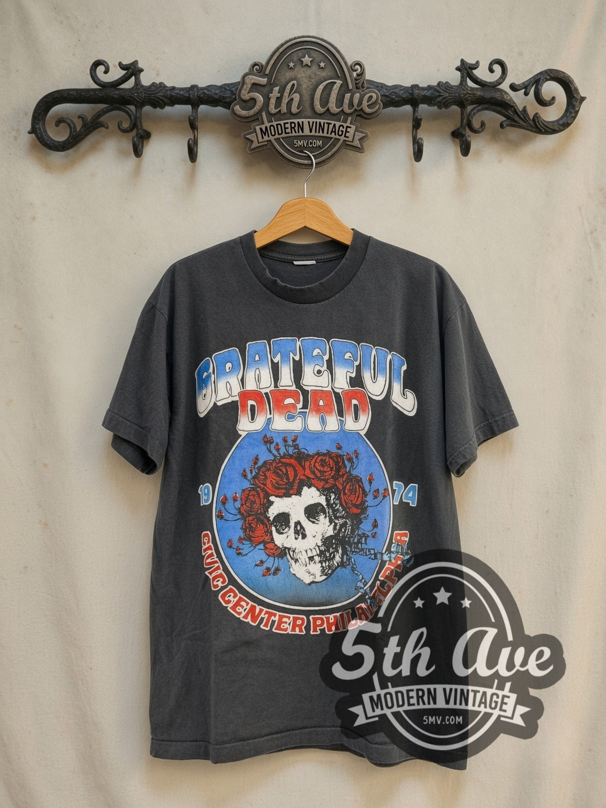 Grateful Dead Live at Philadelphia Civic Center 1974 vintage band t-shirt in black, front view on a display rack