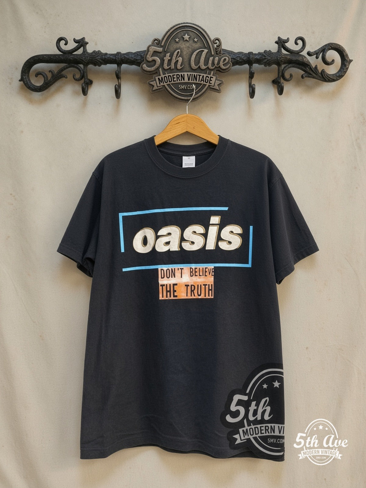Oasis – Don't Believe the Truth World Tour 2005 – Vintage Band T-Shirt — front on locked cream ornate 5th Ave rack