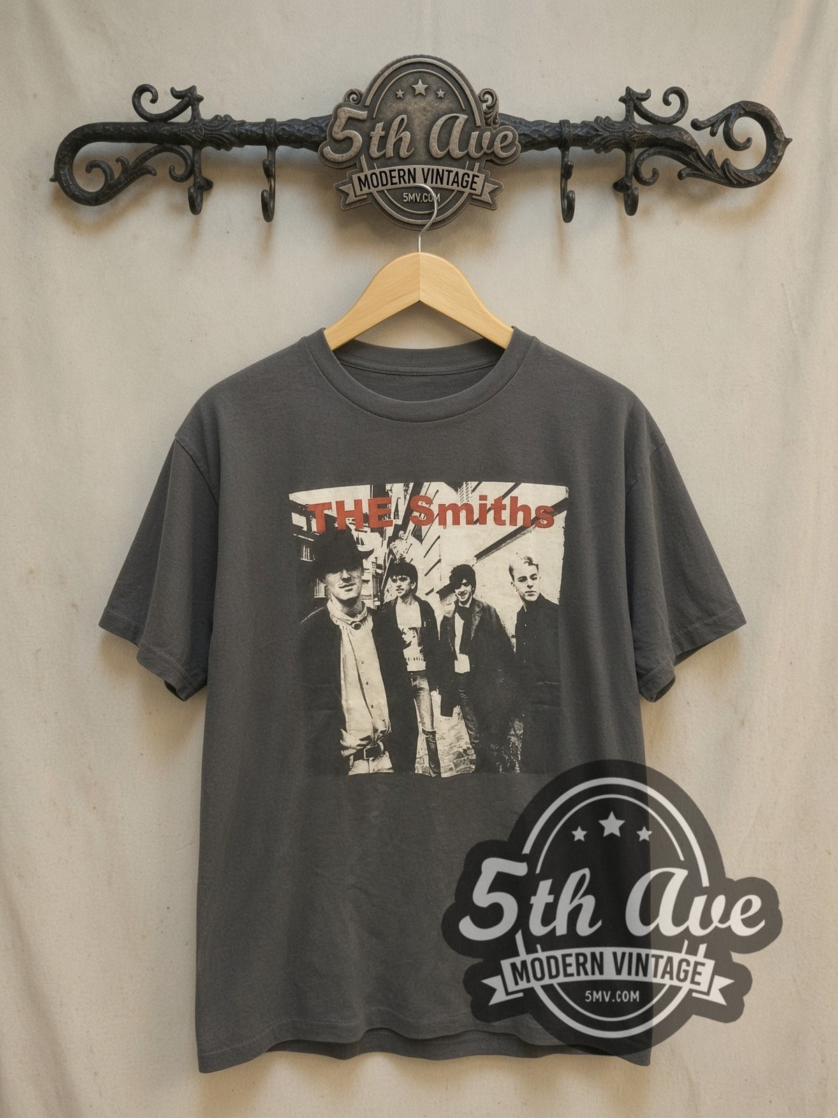 The Smiths Alleyway Band Photo Red Logo vintage band t-shirt, front view on a display rack