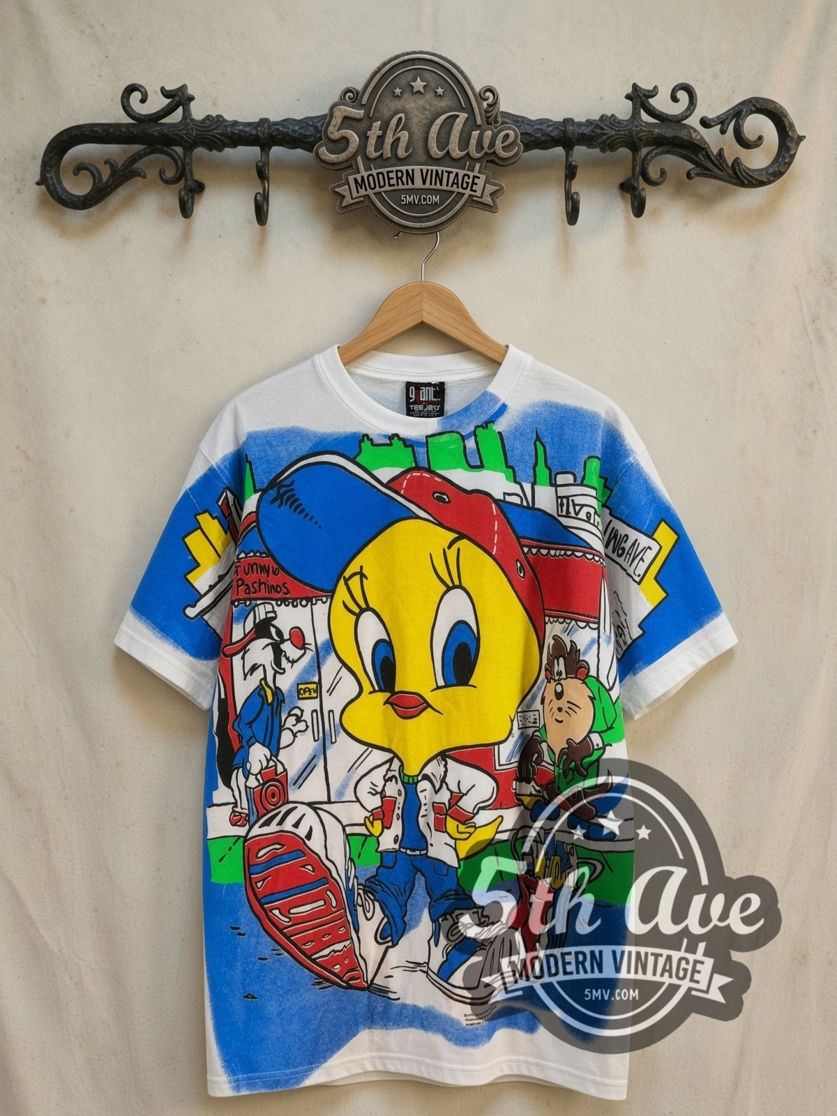 Looney Tunes Tweety, Taz and Sylvester all-over-print graphic tee, front view on a display rack