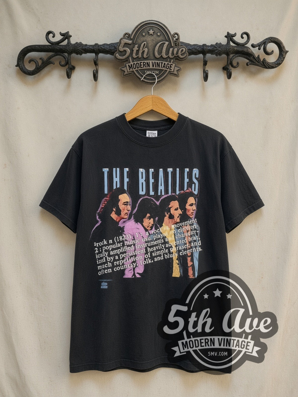 The Beatles Definition of Rock vintage band t-shirt in black, front view on a display rack