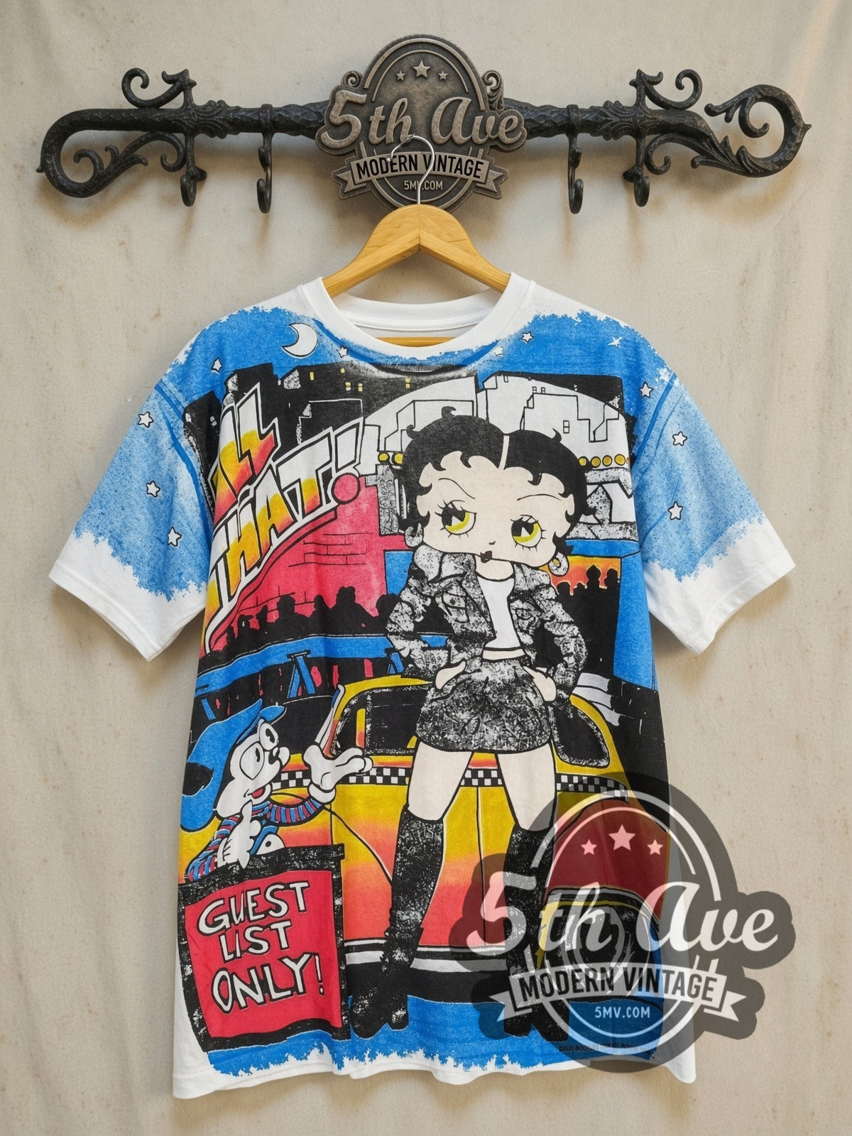 Betty Boop Guest List Only all-over-print vintage cartoon tee, front view on a display rack