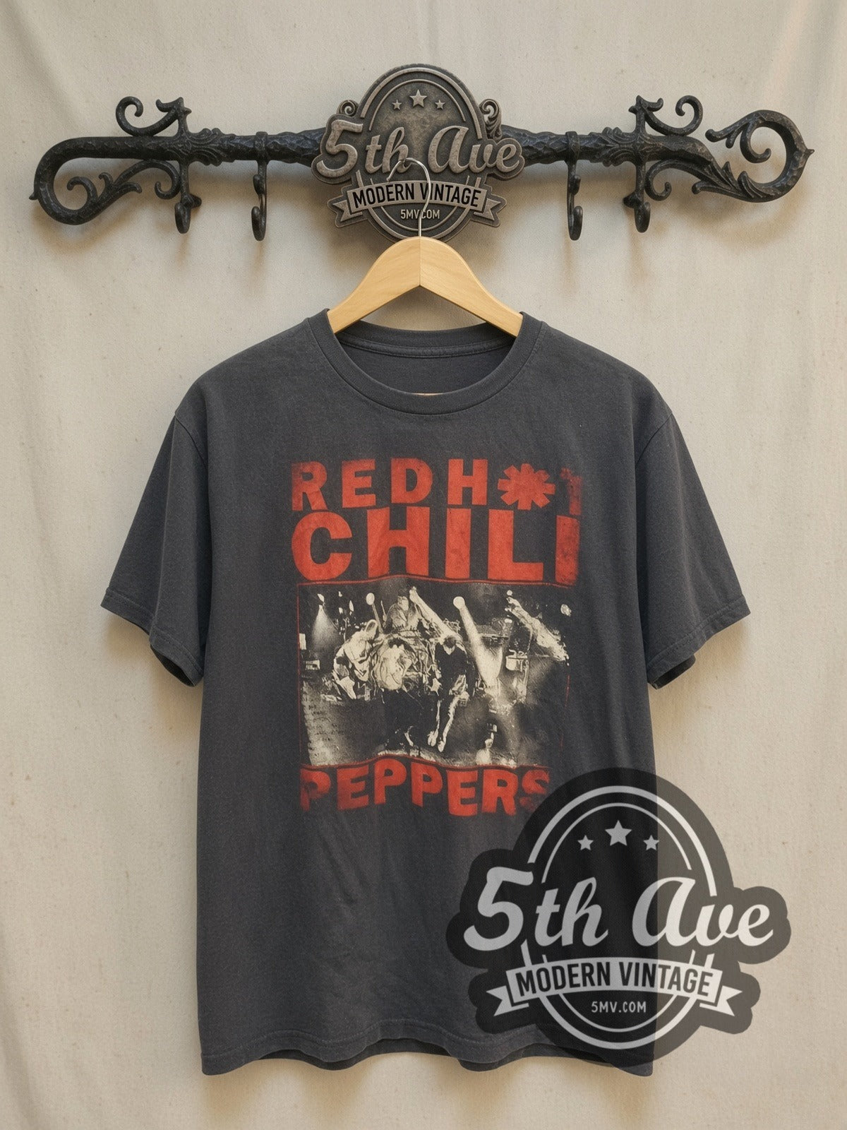 Red Hot Chili Peppers Distressed Red Text Live Stage Shot vintage band t-shirt, front view on a display rack